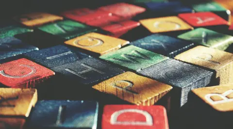 Wooden letter cubes arranged to spell words