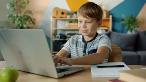 A person learning online with a laptop