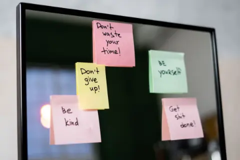 Colorful sticky notes on a glass wall