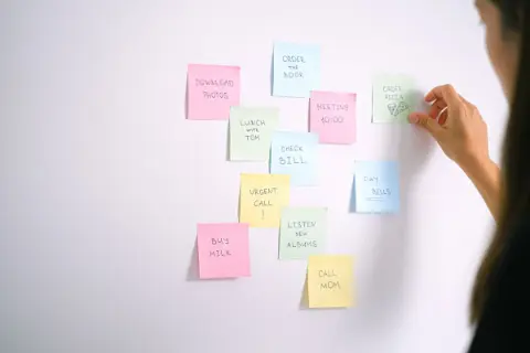 Colorful sticky notes with a to-do list on a white wall