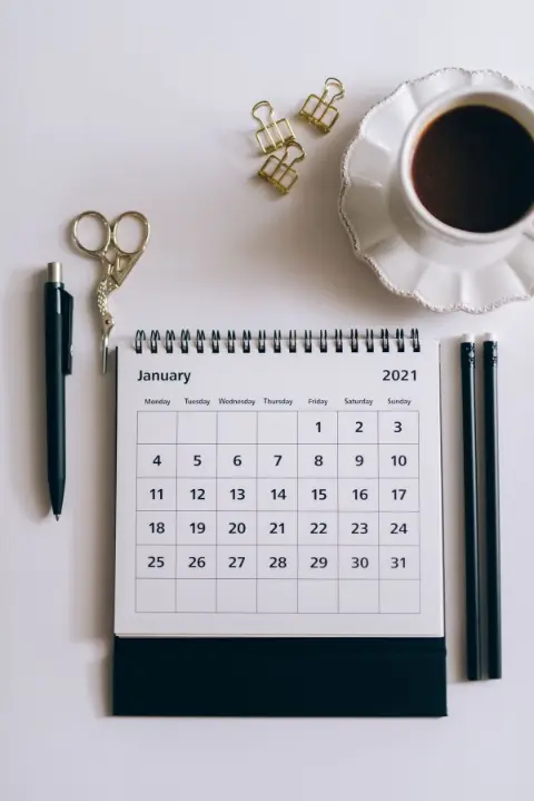 A desk calendar beside a click pen