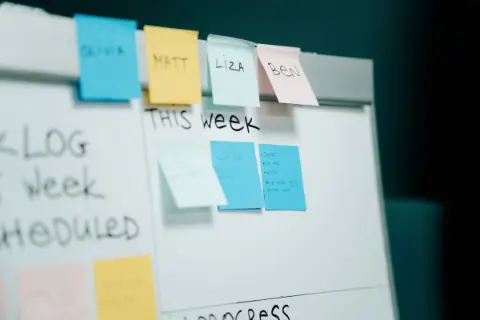 Close-up of colorful sticky notes on a whiteboard