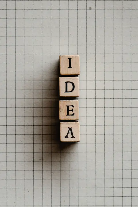 Wooden letter blocks resting on graphing paper