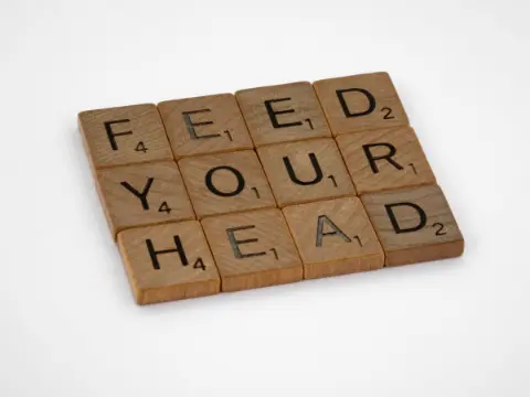 Wooden letter tiles arranged on a white surface